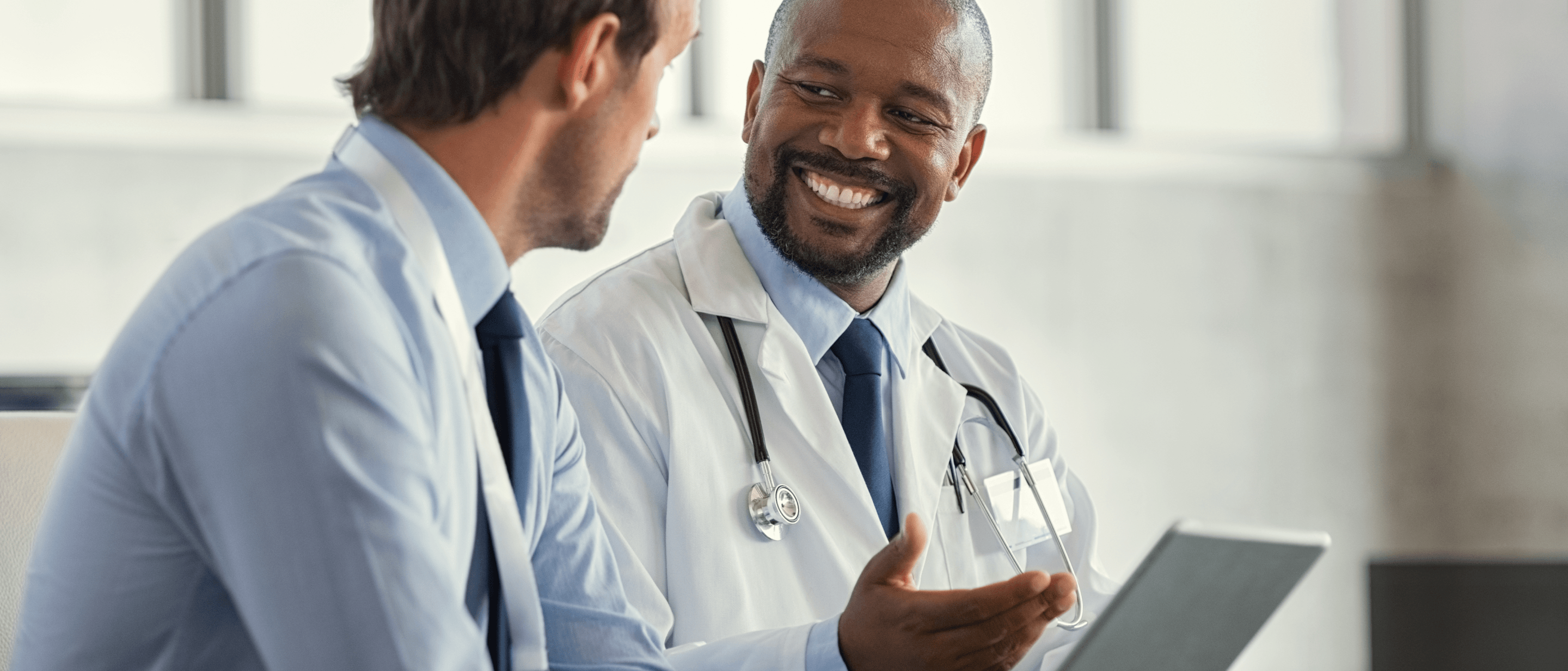 doctor and man talking in an office setting
